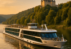 Abstract painting of a modern river cruise ship passing a European castle at sunset with lush greenery